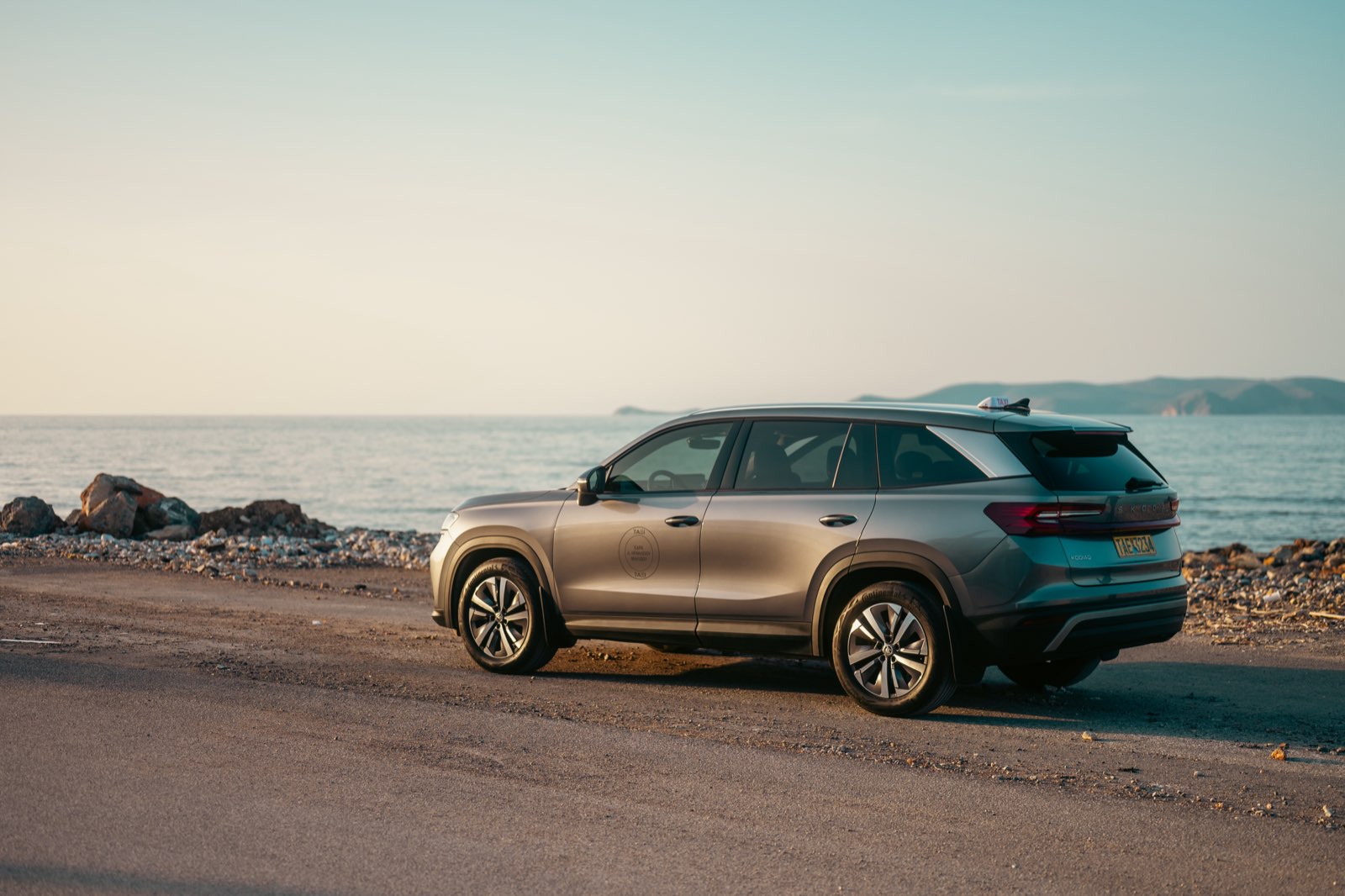 LP Taxi SUV parked by the Cretan seaside at sunset