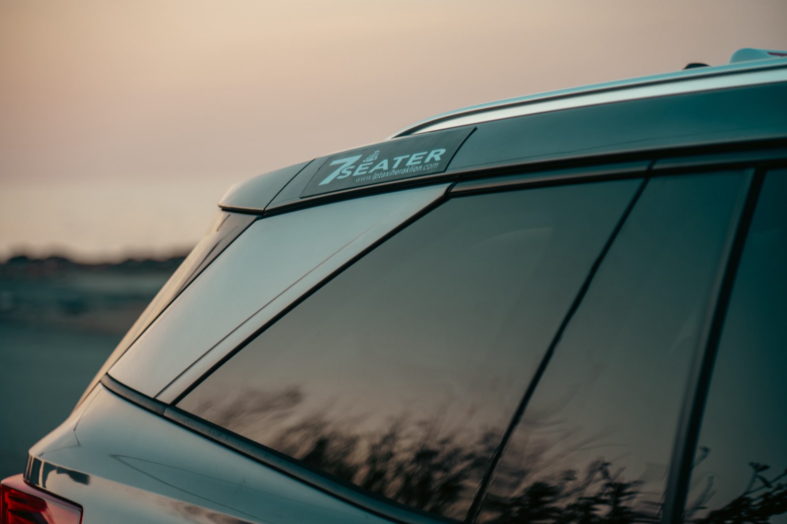 7-seater badge on LP Taxi vehicle rear window